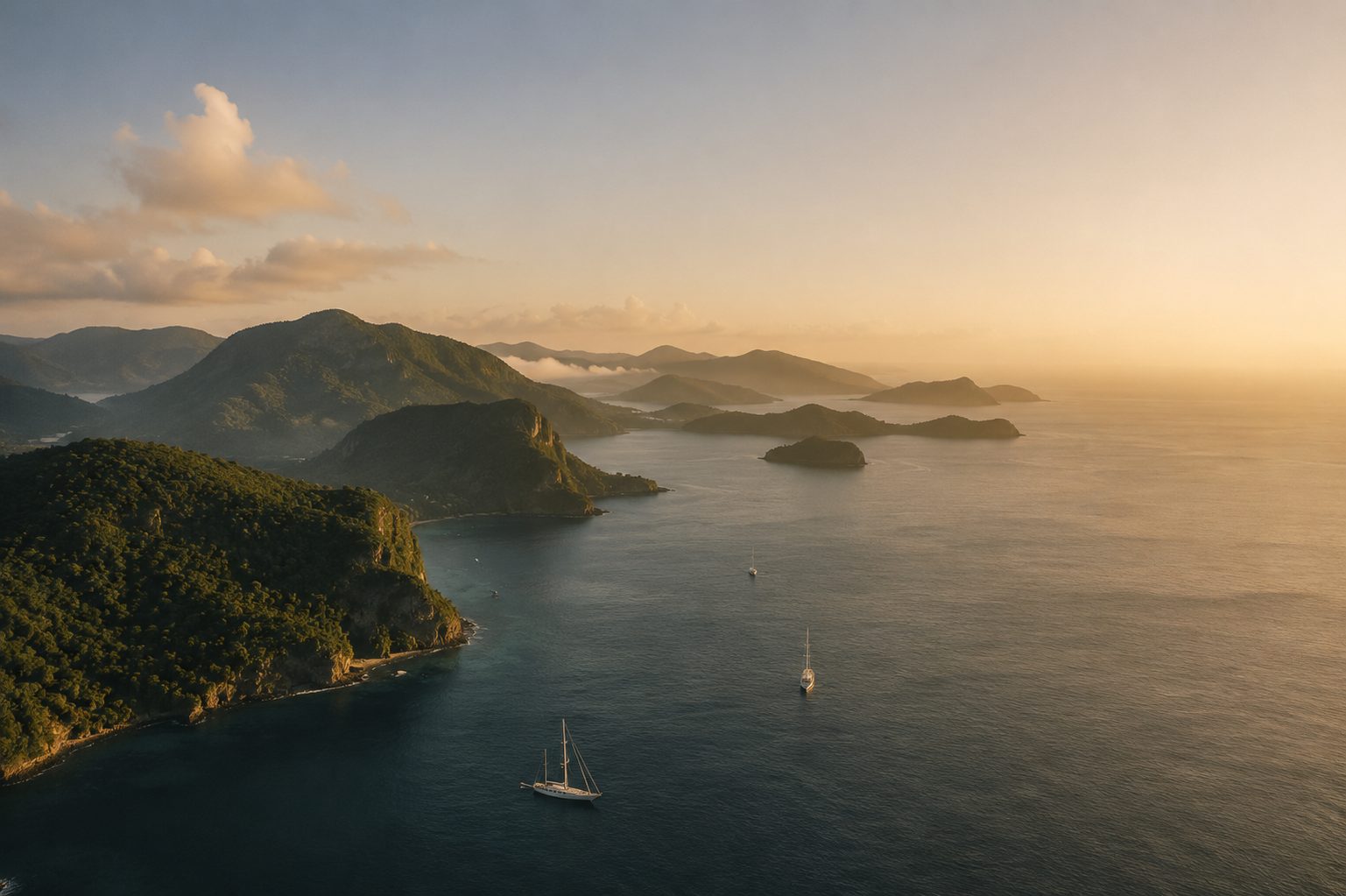 Aerial view of the Grenadines archipelago at golden hour, islands and yachts set in deep blue sea